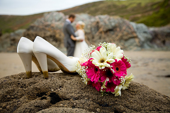Bride's Shoes and Flowers on a Beach Cornwall wedding photography