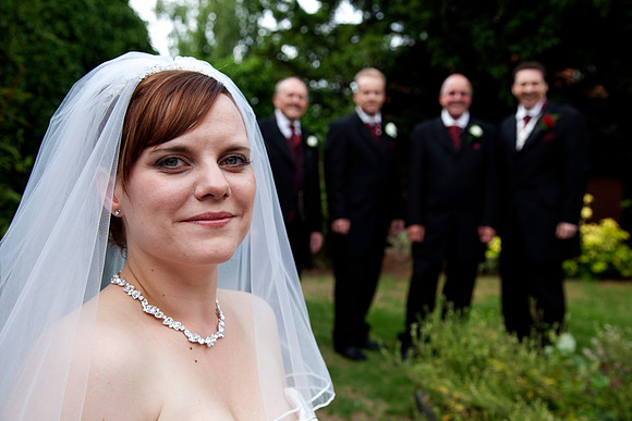 picture of the bride groom and groom's men in the background