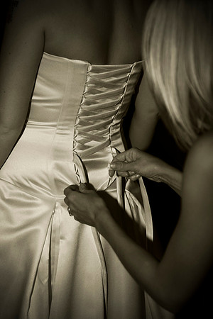 wedding Photographer Bristol and Leicestershire - Getting Ready, A bride's maid adjusts the bride's wedding dress