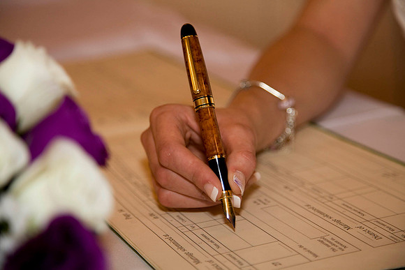 Bride Signing the Wedding Register
